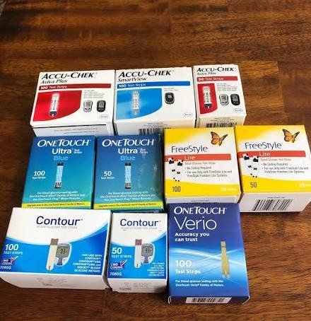A lot of unused diabetic test strip boxes laid out on a table for a quote